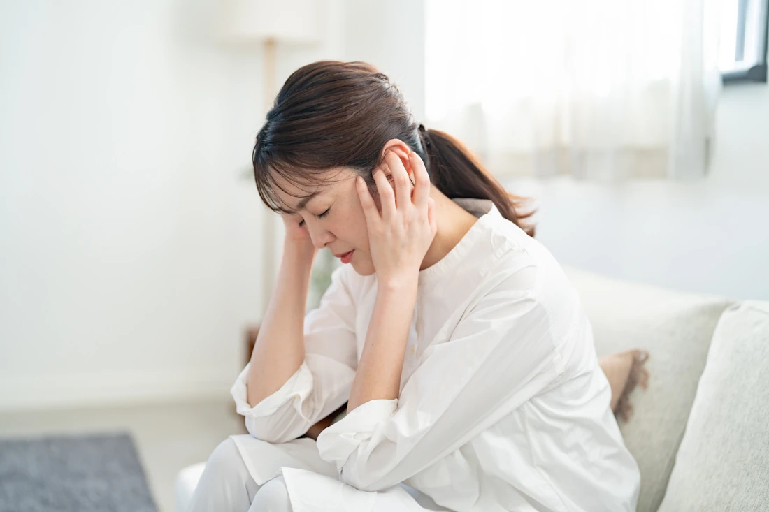 目を押さえている女性